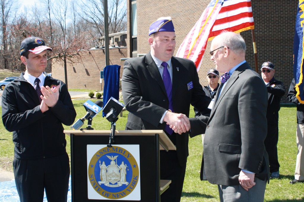 Caption: Tully Rinckey PLLC Founding Partner and New York State Commander of the Military Order of the Purple Heart Mathew Tully, along with state Assemblyman Angelo Santabarabara, thank miSci Executive Director Mac Sudduth for the museum’s dedication of a designated combat-wounded parking space. 