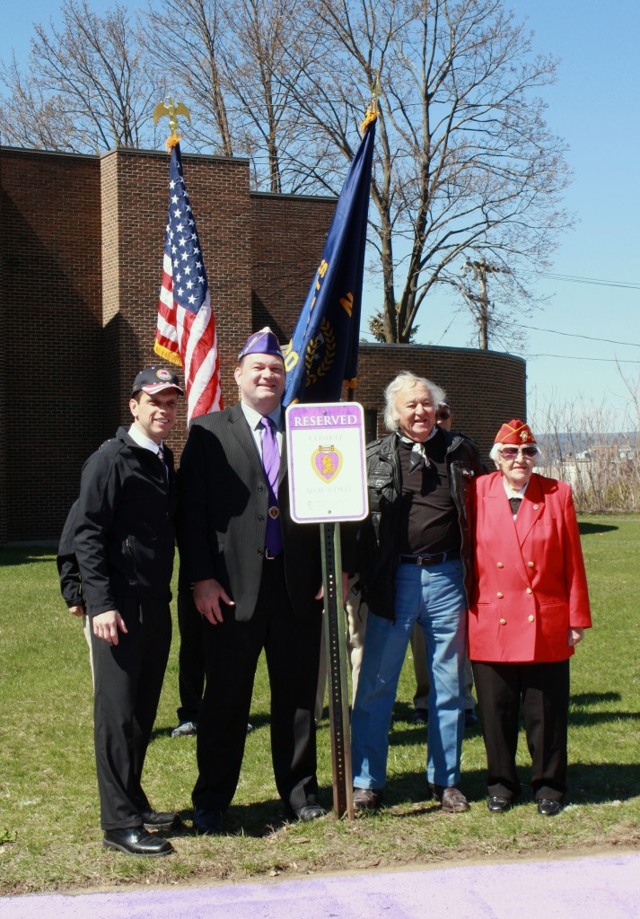 Caption: State Assemblyman Angelo Santabarabara, Tully Rinckey PLLC Founding Partner and New York State Commander of the Military Order of the Purple Heart Mathew Tully, Princetown Highway Superintendent and Purple Heart Korean War veteran Nicholas Maura Sr., and Marion M. Grimes from the Electric City Detachment Marine Corps League stand with the new designated parking spot at miSci. 
