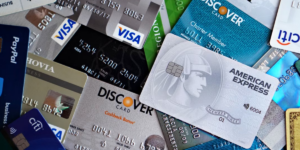 an assortment of Visa credit cards spread out in a jumble
