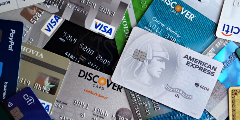 an assortment of Visa credit cards spread out in a jumble